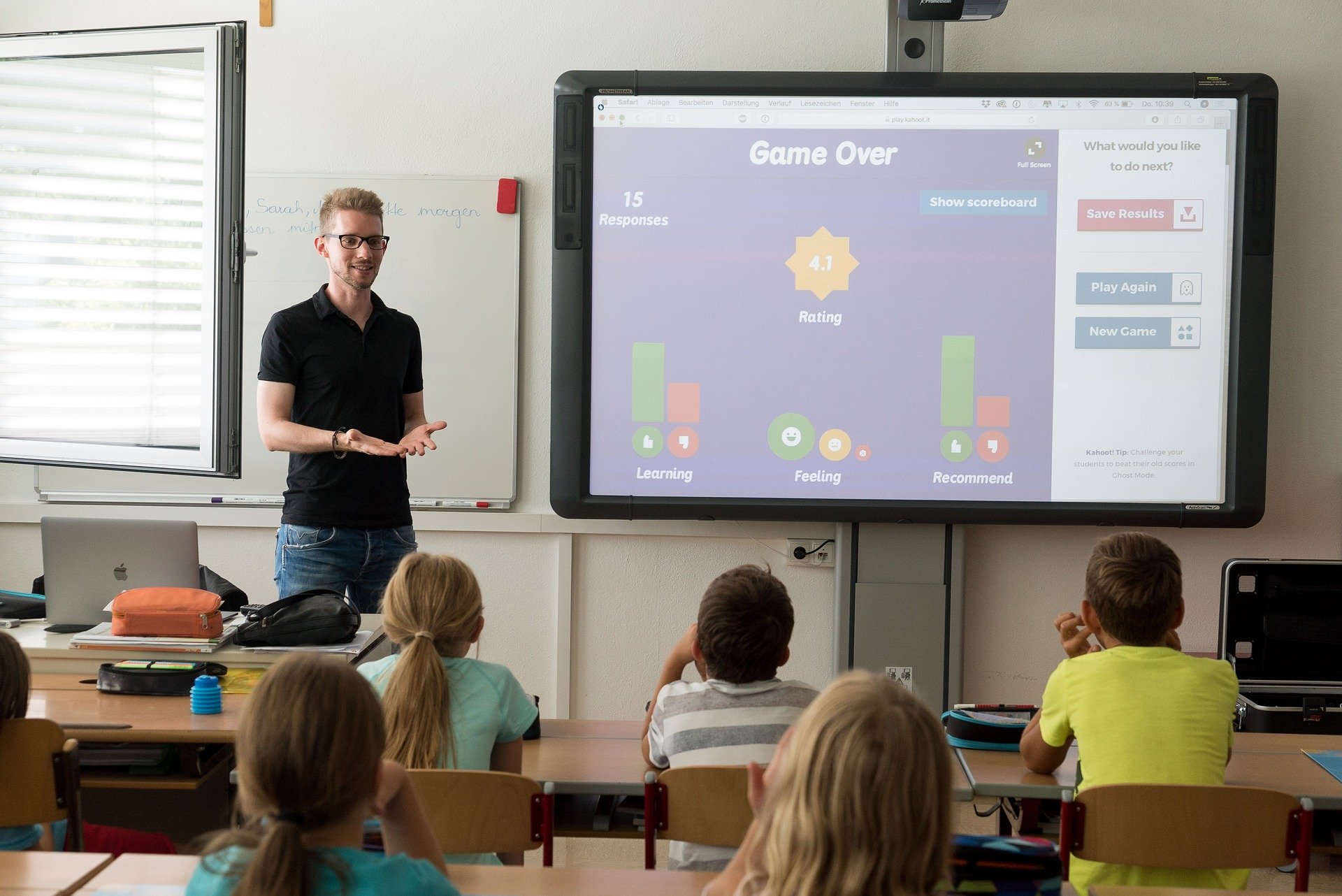 Teacher stands in front of a classroom, using gamification to align Bloom