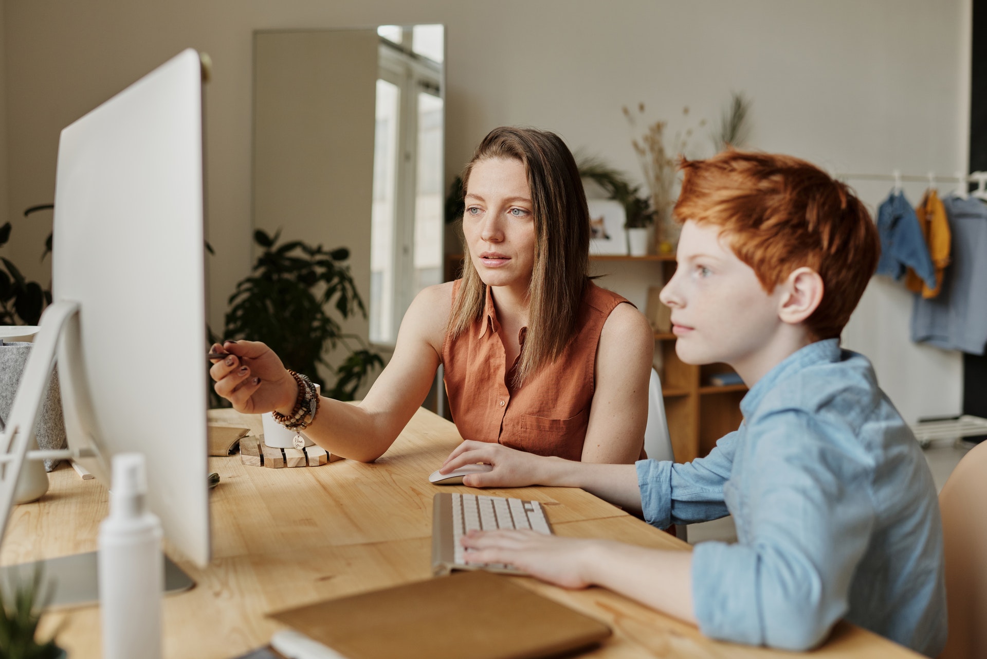 A parent and student sit on a computer during test prep season.