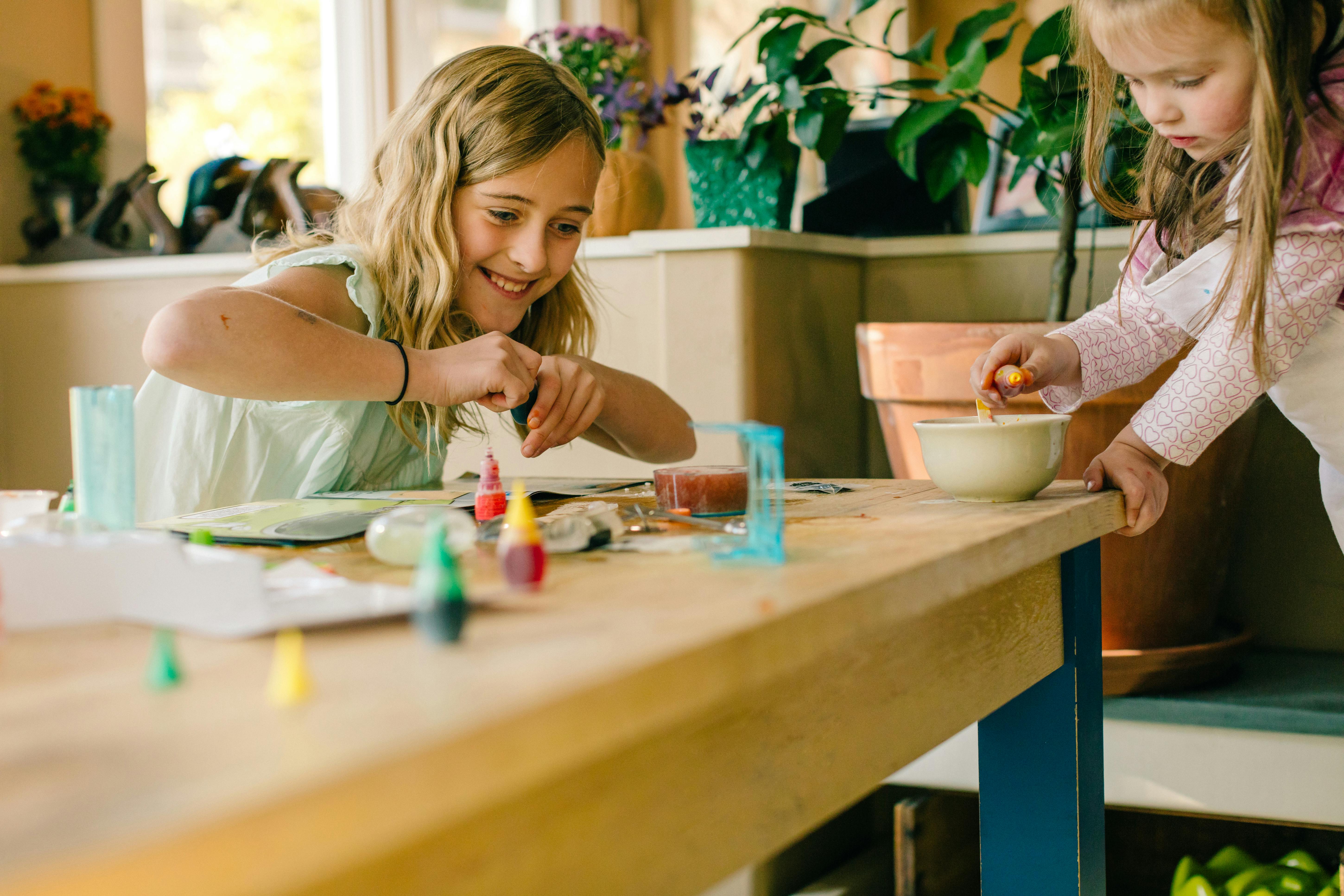 Two girls doing science experiment at table