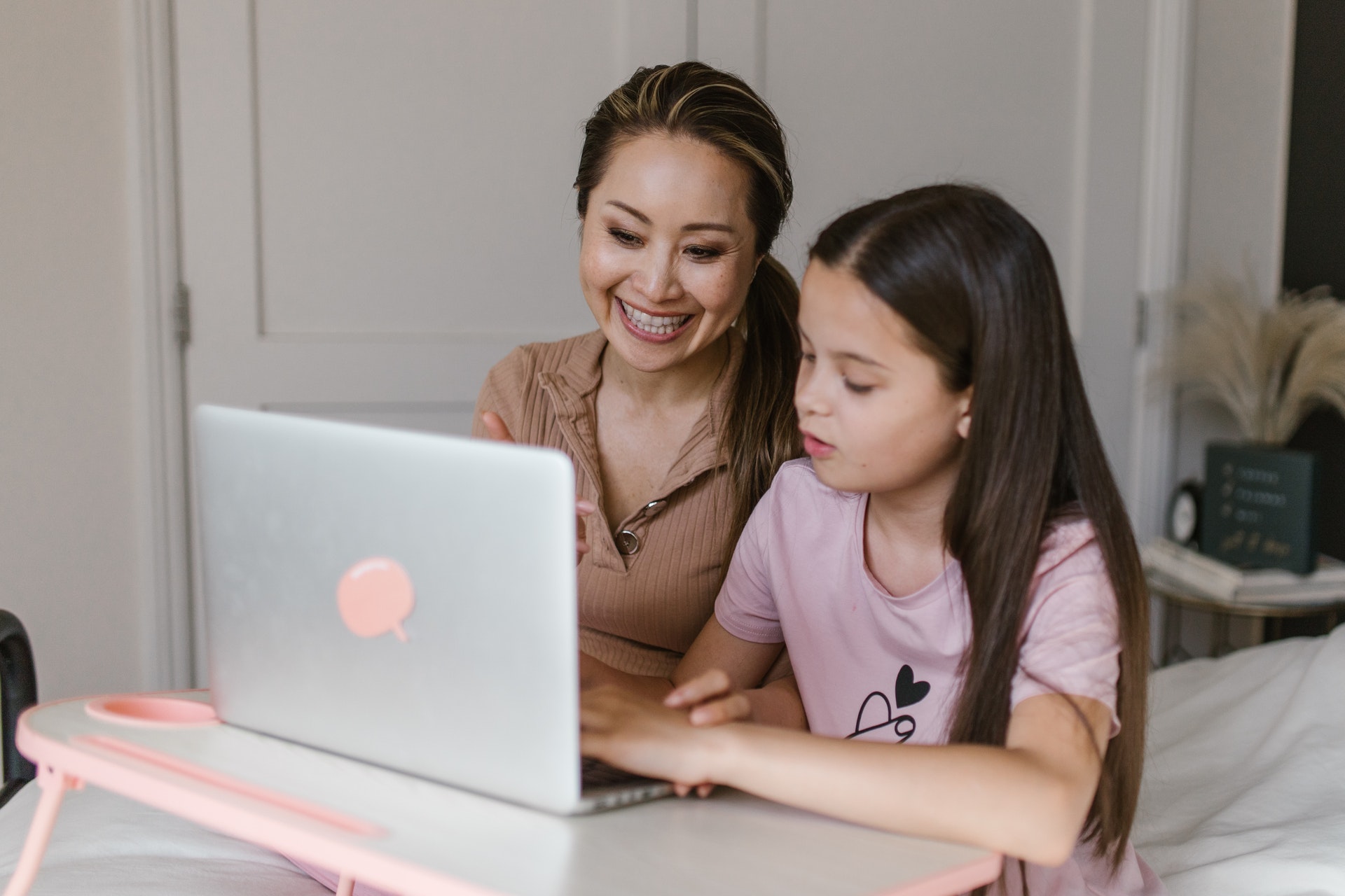 A tutor and a child work together at a computer during one-on-one tutoring.