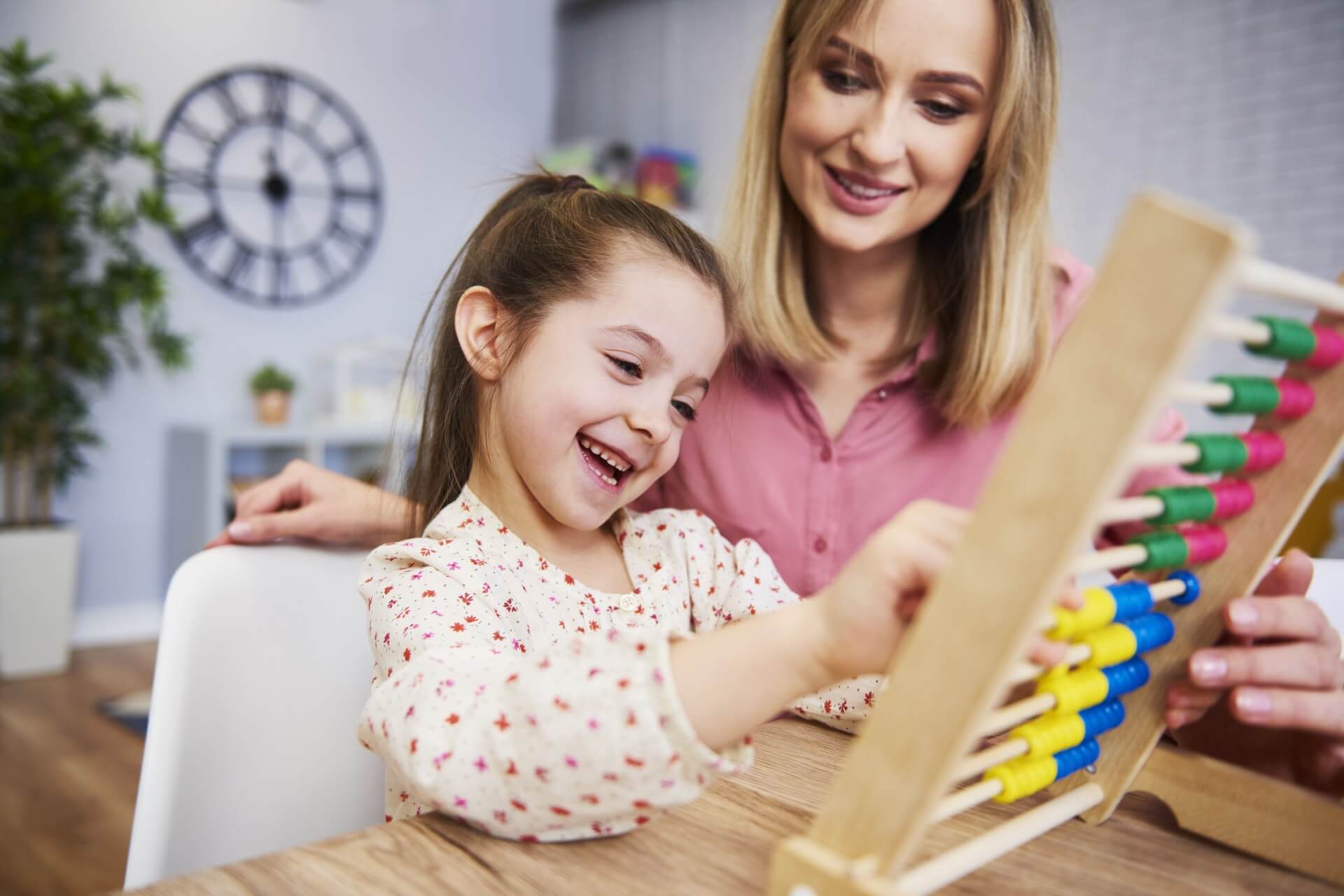 Mom using abacus to homeschool her child.