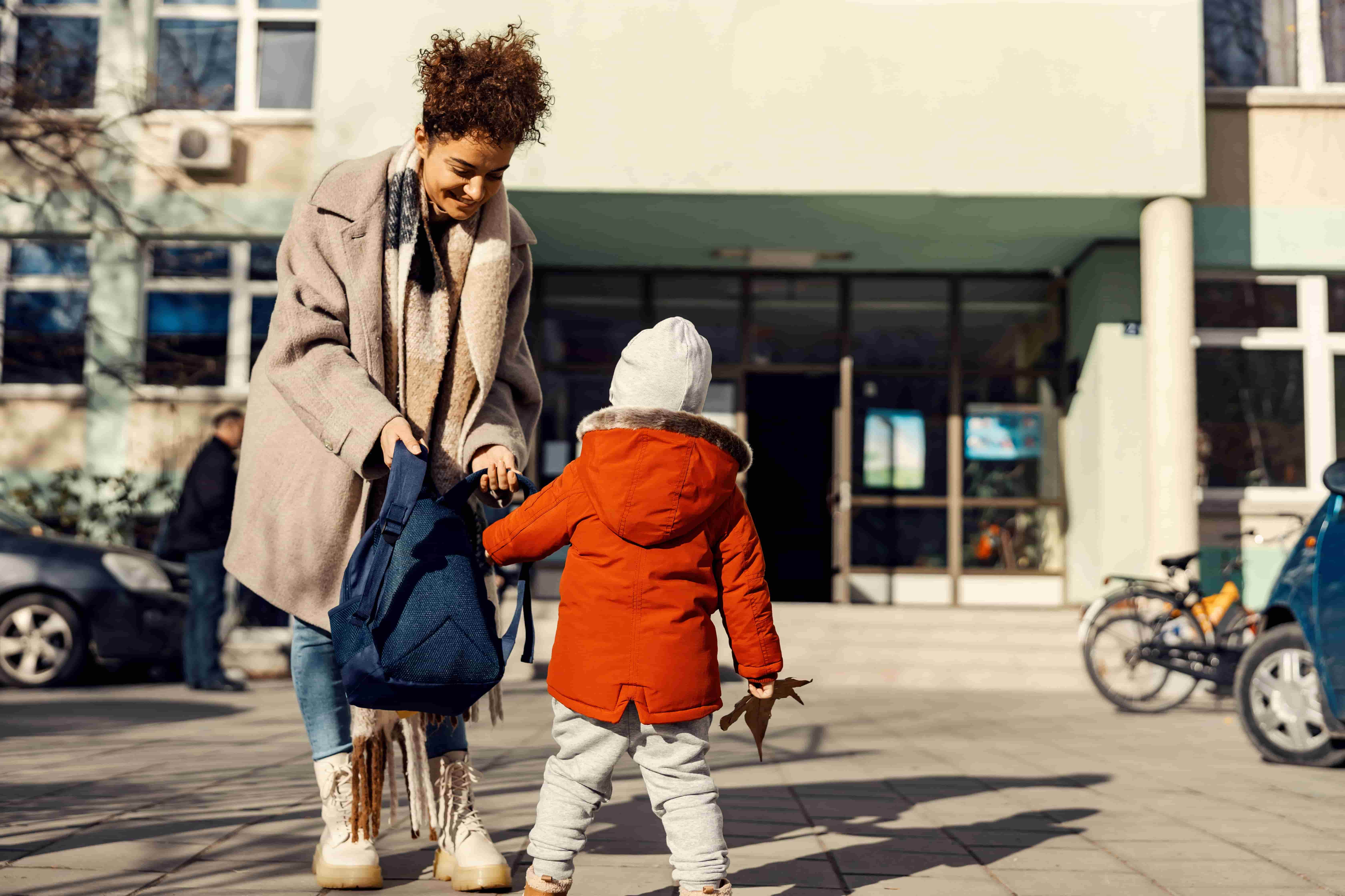 Mom collects her child from school.