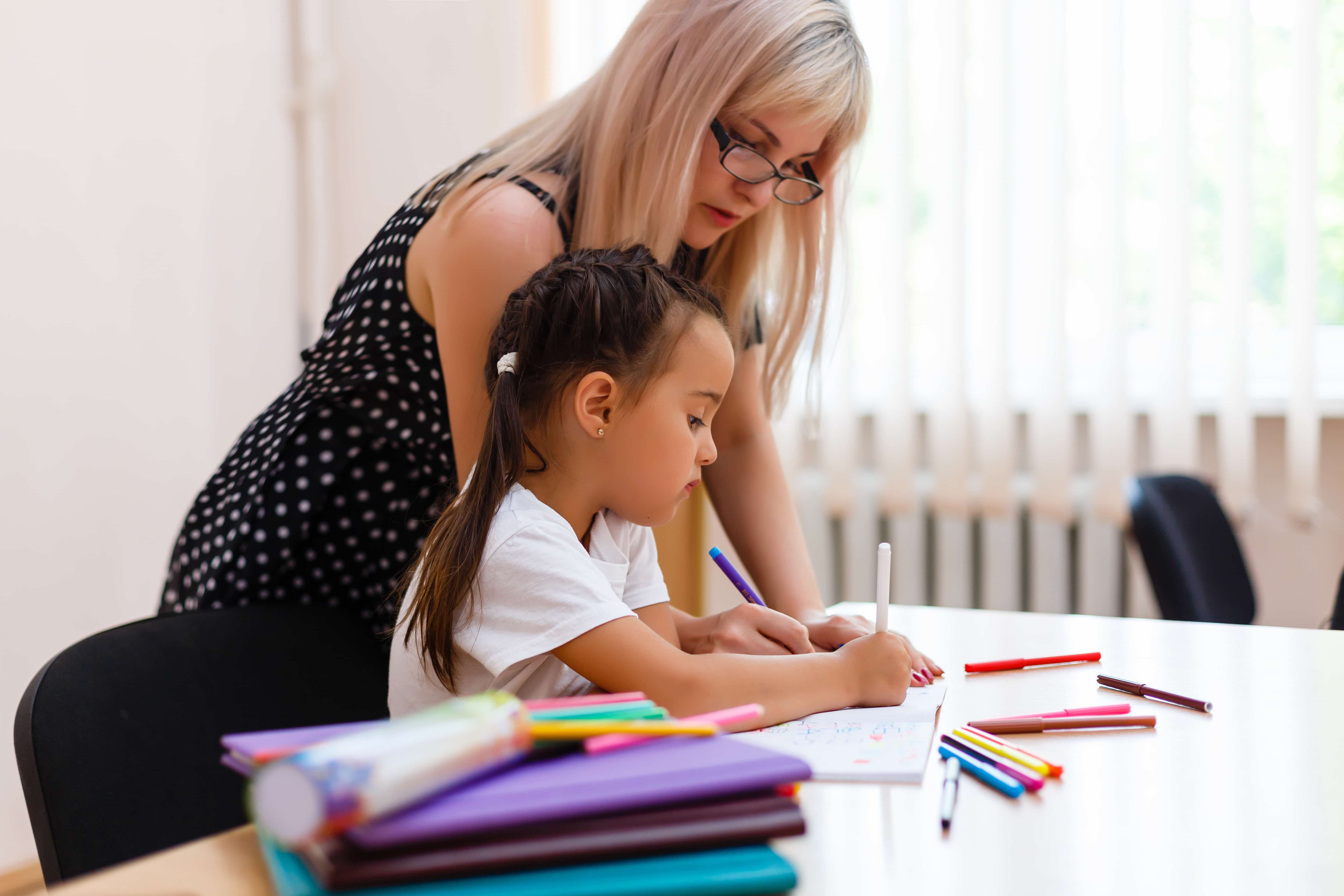 A teacher helping a student create a portfolio.