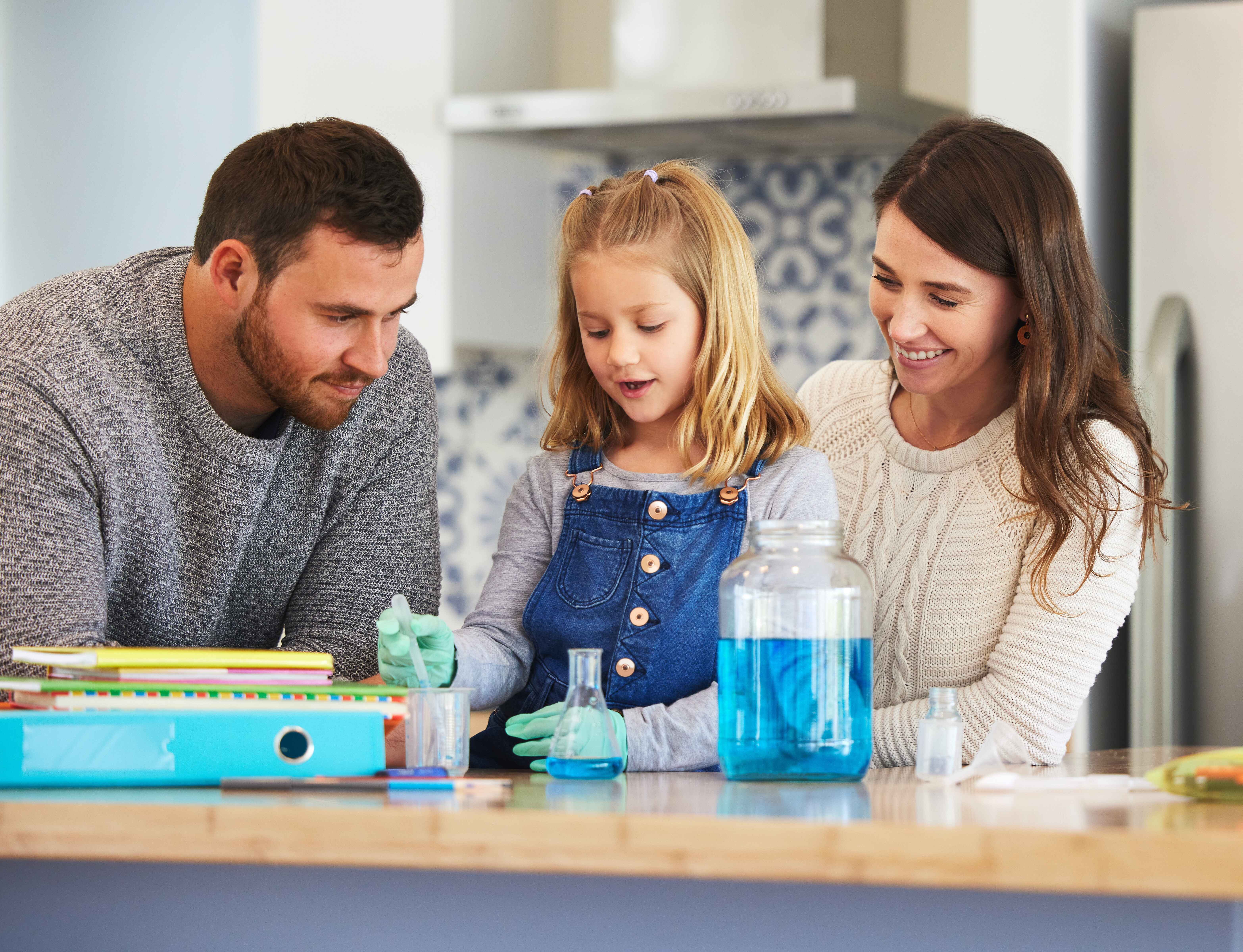 What did your notes say. Shot of a family completing science experiments at home.